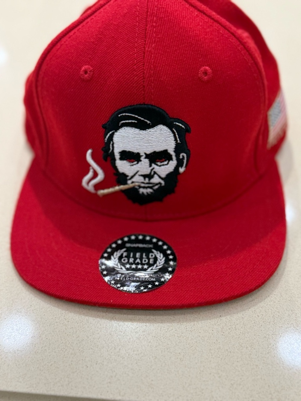 Red Snapback Hat with Embroidered Abe Lincoln Design